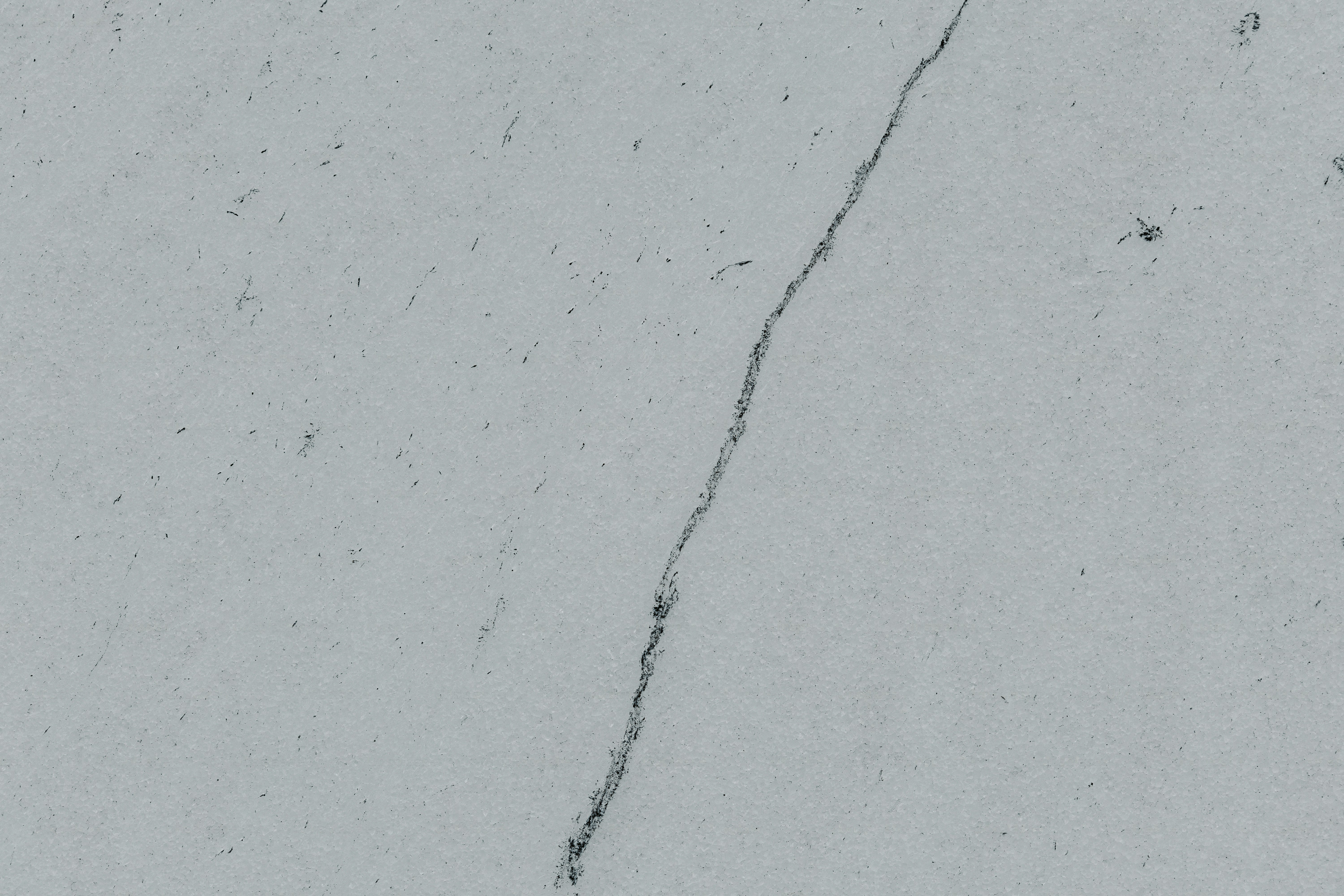 a crack in the side of a white wall