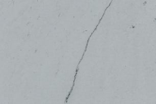 a crack in the side of a white wall
