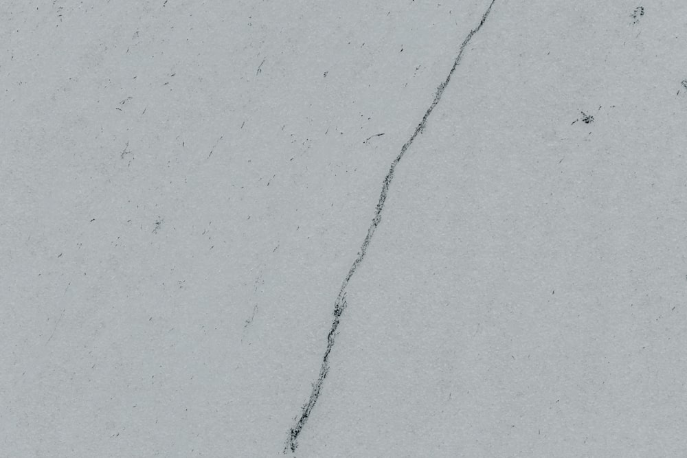 a crack in the side of a white wall