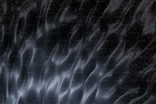 a black and white photo of a wavy surface