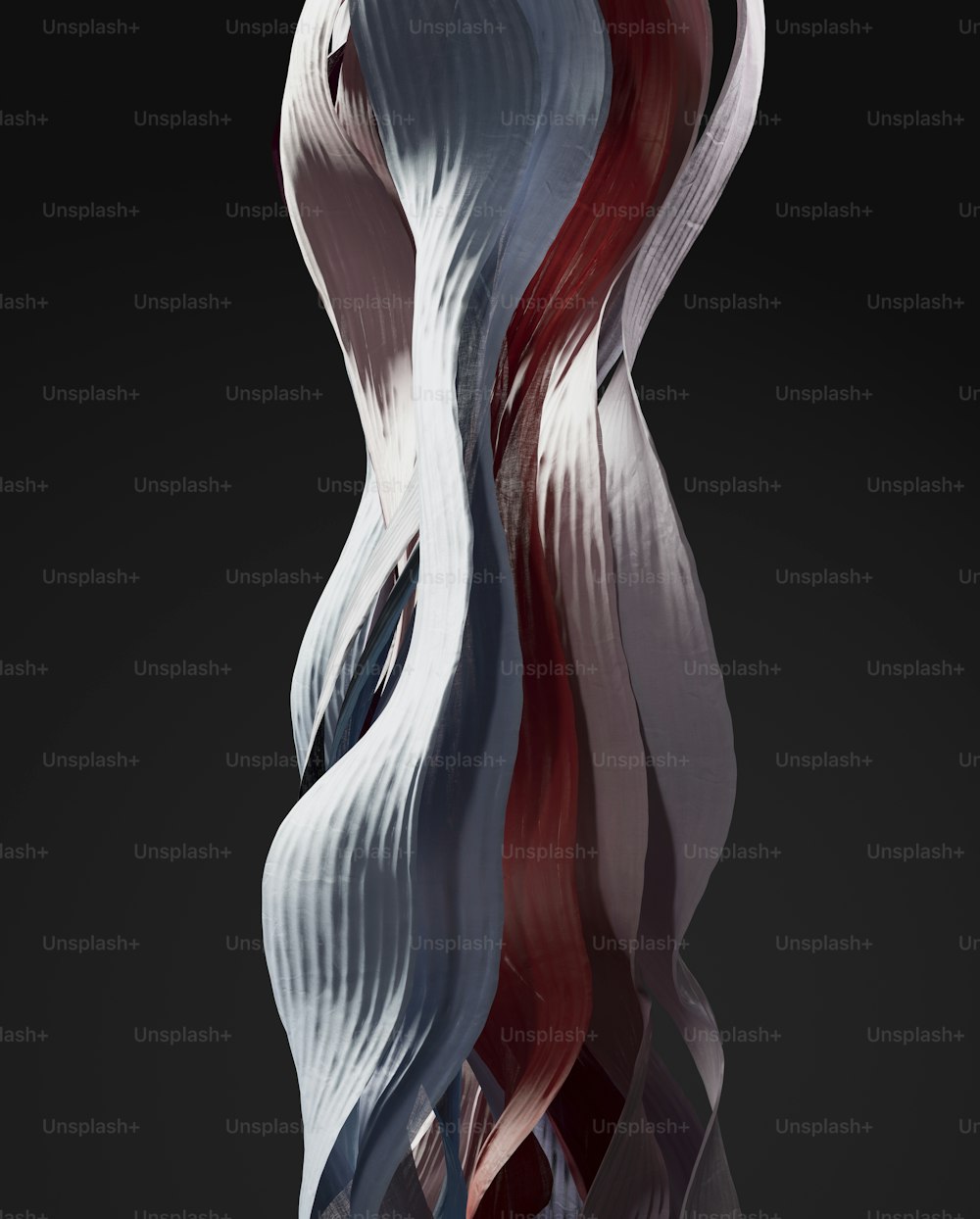 a tall white and red sculpture on a black background