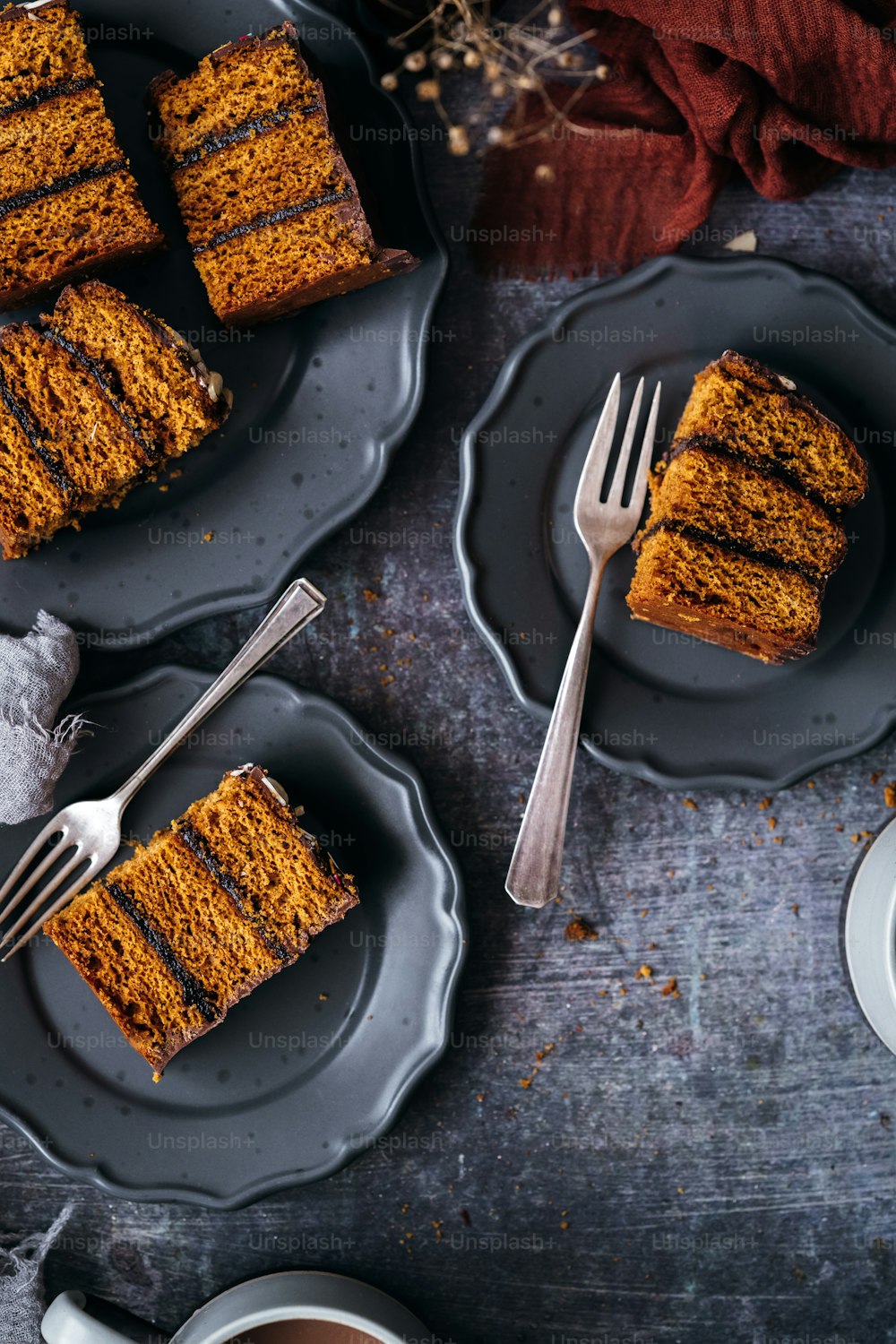 slices of pumpkin spice cake on plates with a fork
