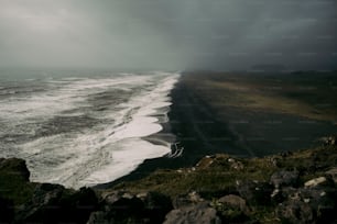 a large body of water near a rocky shore