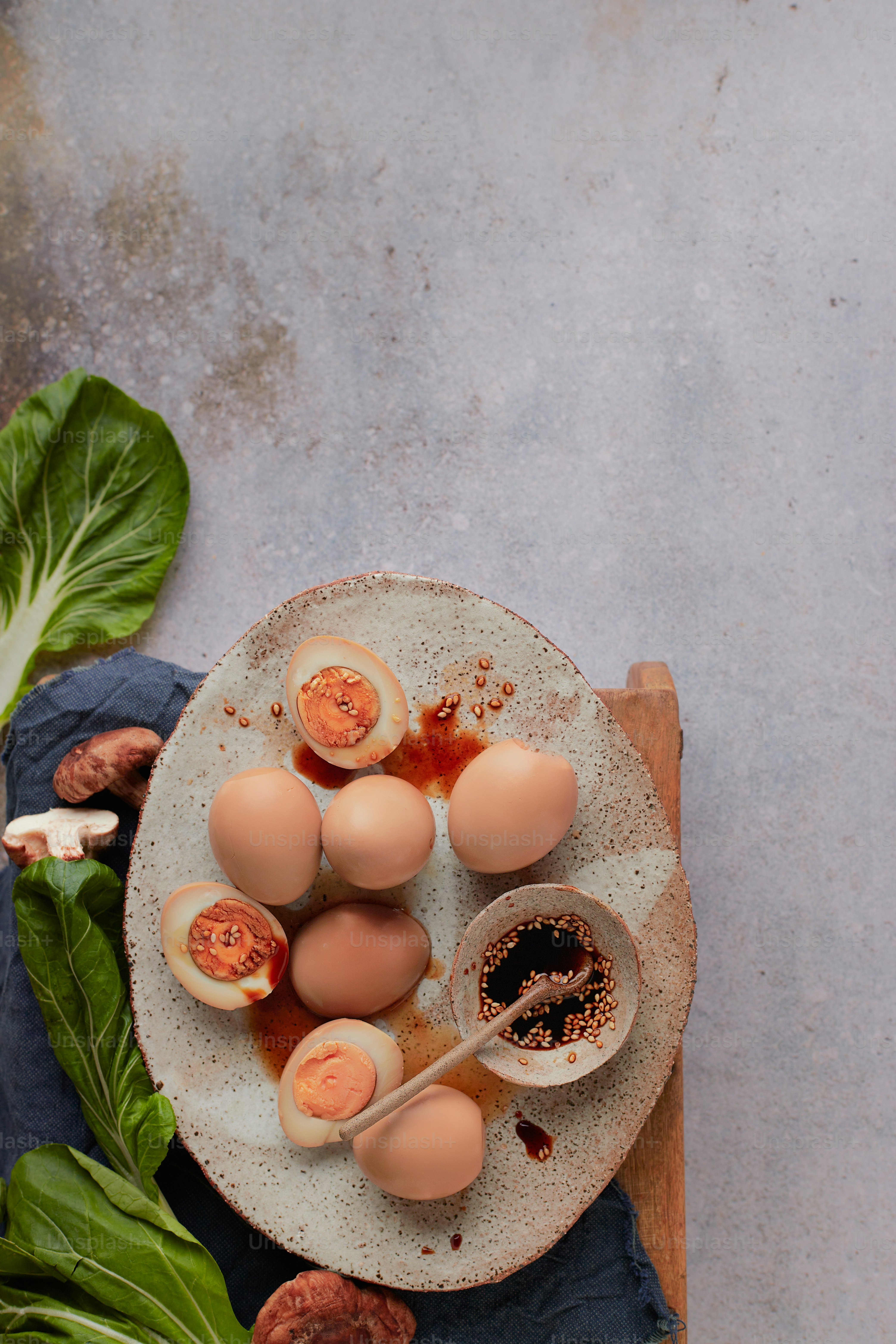 a white plate topped with eggs on top of a wooden cutting board