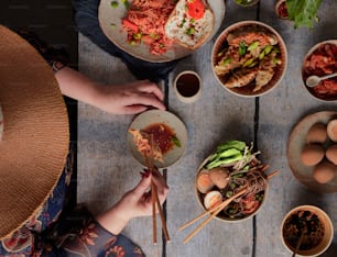 a table topped with bowls and plates of food