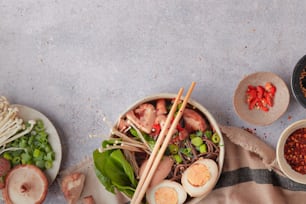 a table topped with bowls of food and chopsticks