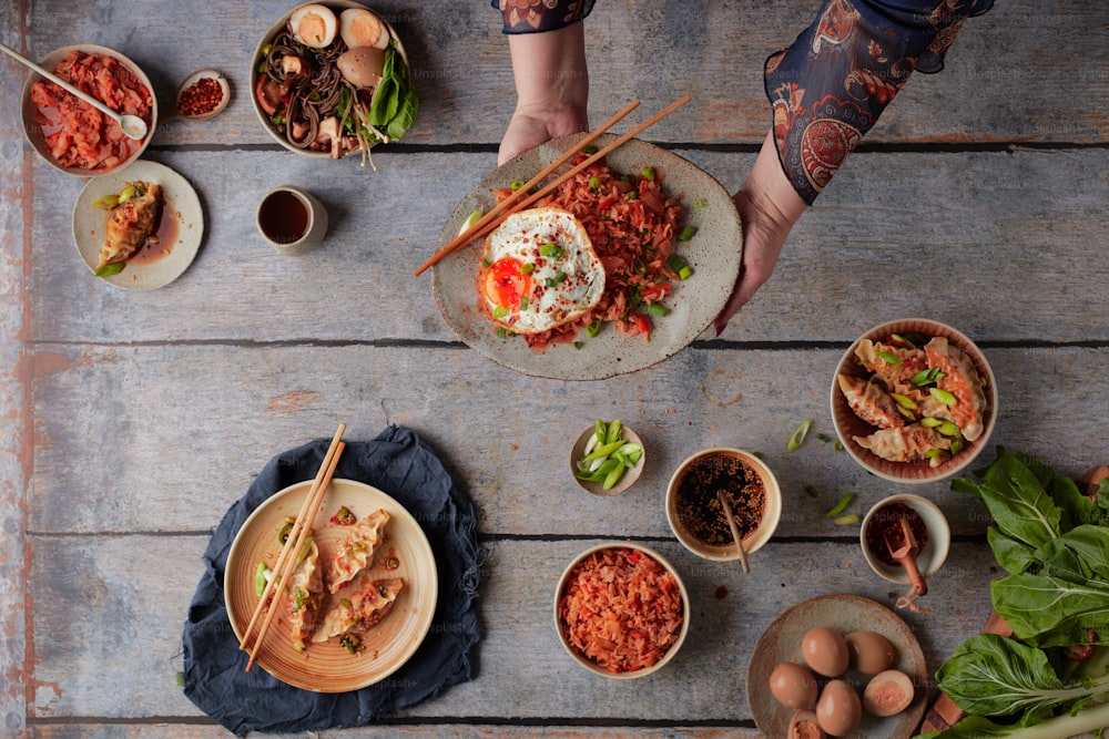 uma mesa coberta com pratos de comida e pauzinhos