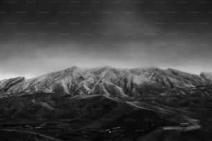 a black and white photo of a mountain range