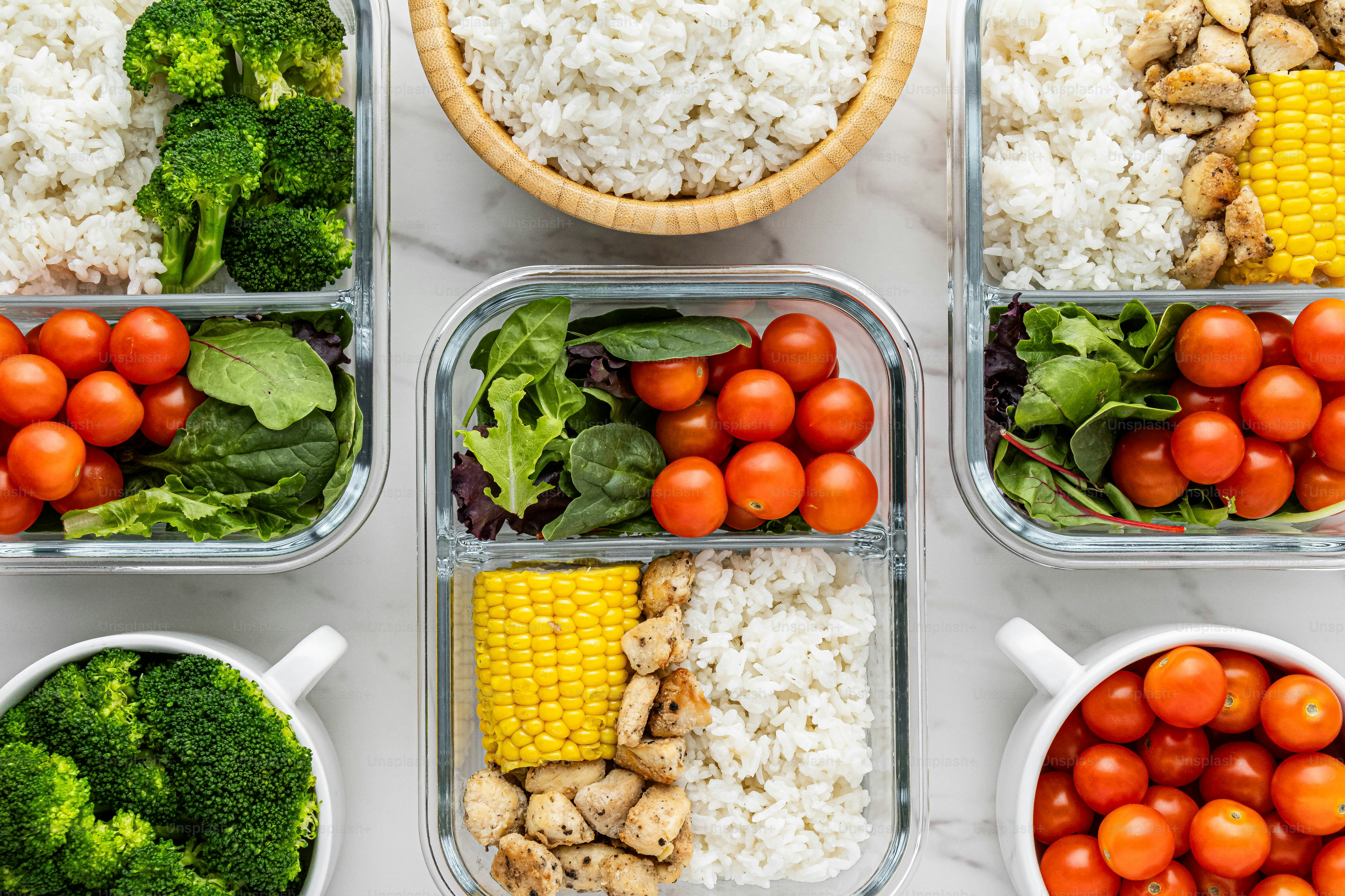 four containers filled with different types of food