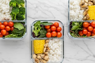 three plastic containers filled with different types of food