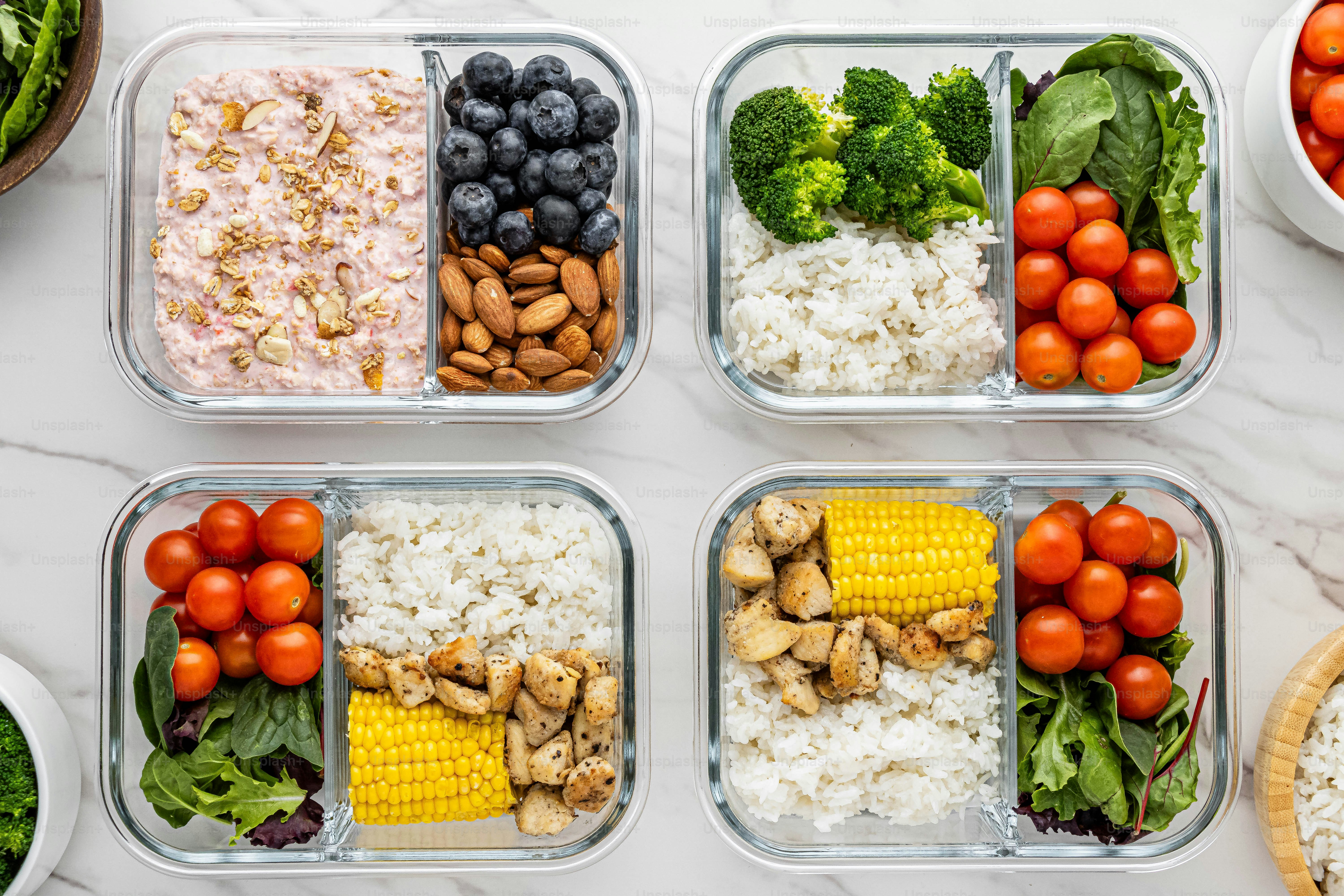four plastic containers filled with different types of food