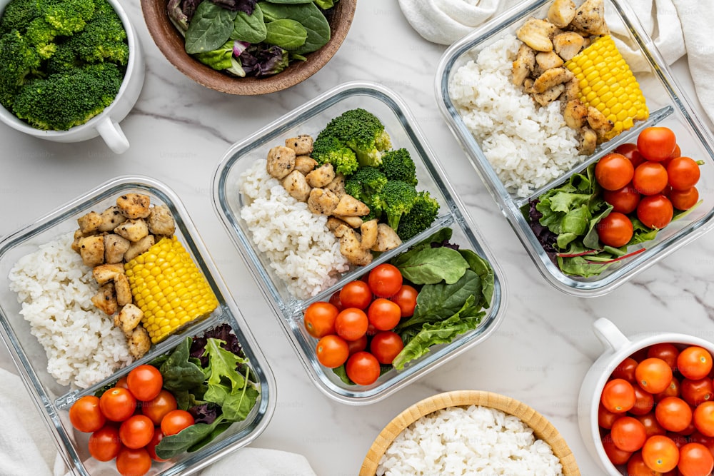 a table topped with containers filled with different types of food