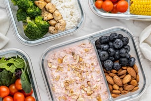 a table topped with containers filled with different types of food