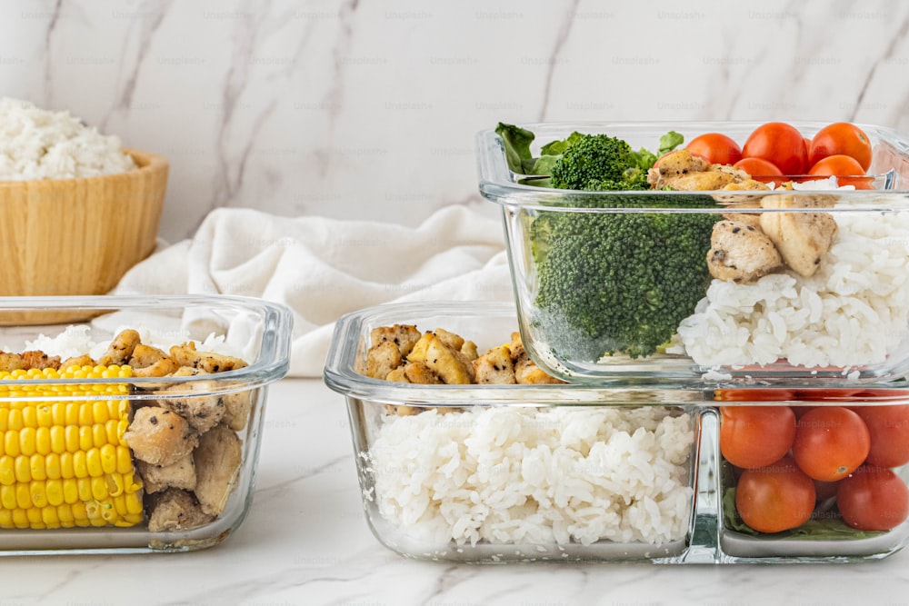 a table topped with containers filled with different types of food