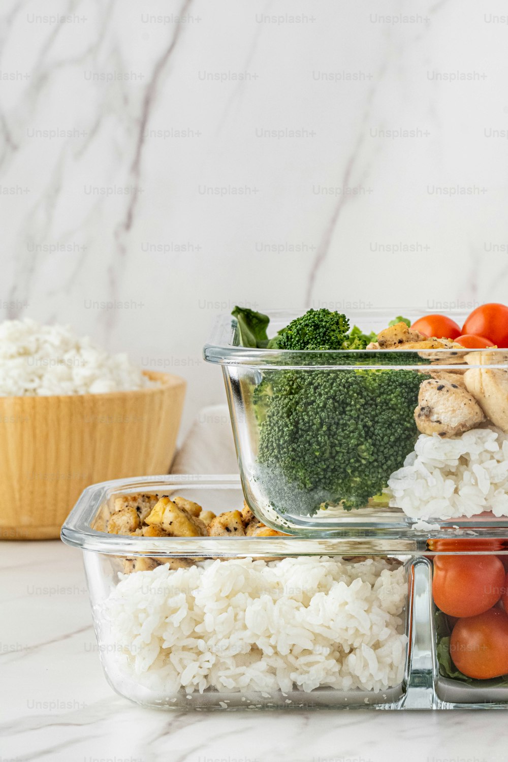 a table topped with containers filled with rice and veggies