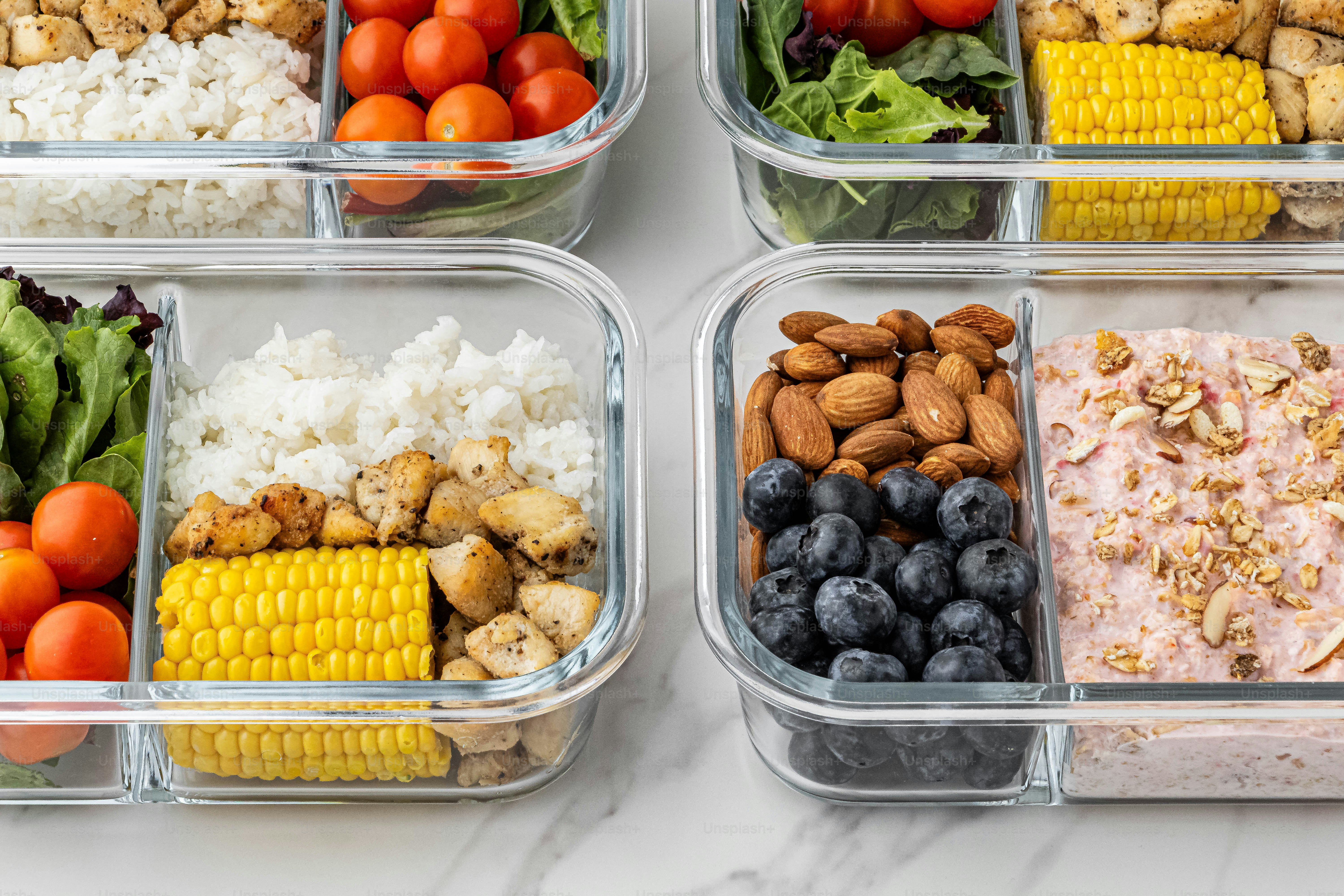 four plastic containers filled with different types of food