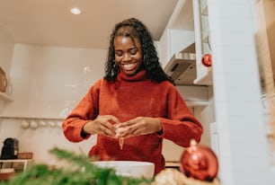 a woman standing in a kitchen preparing food