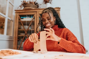 a woman sitting at a table with a piece of paper