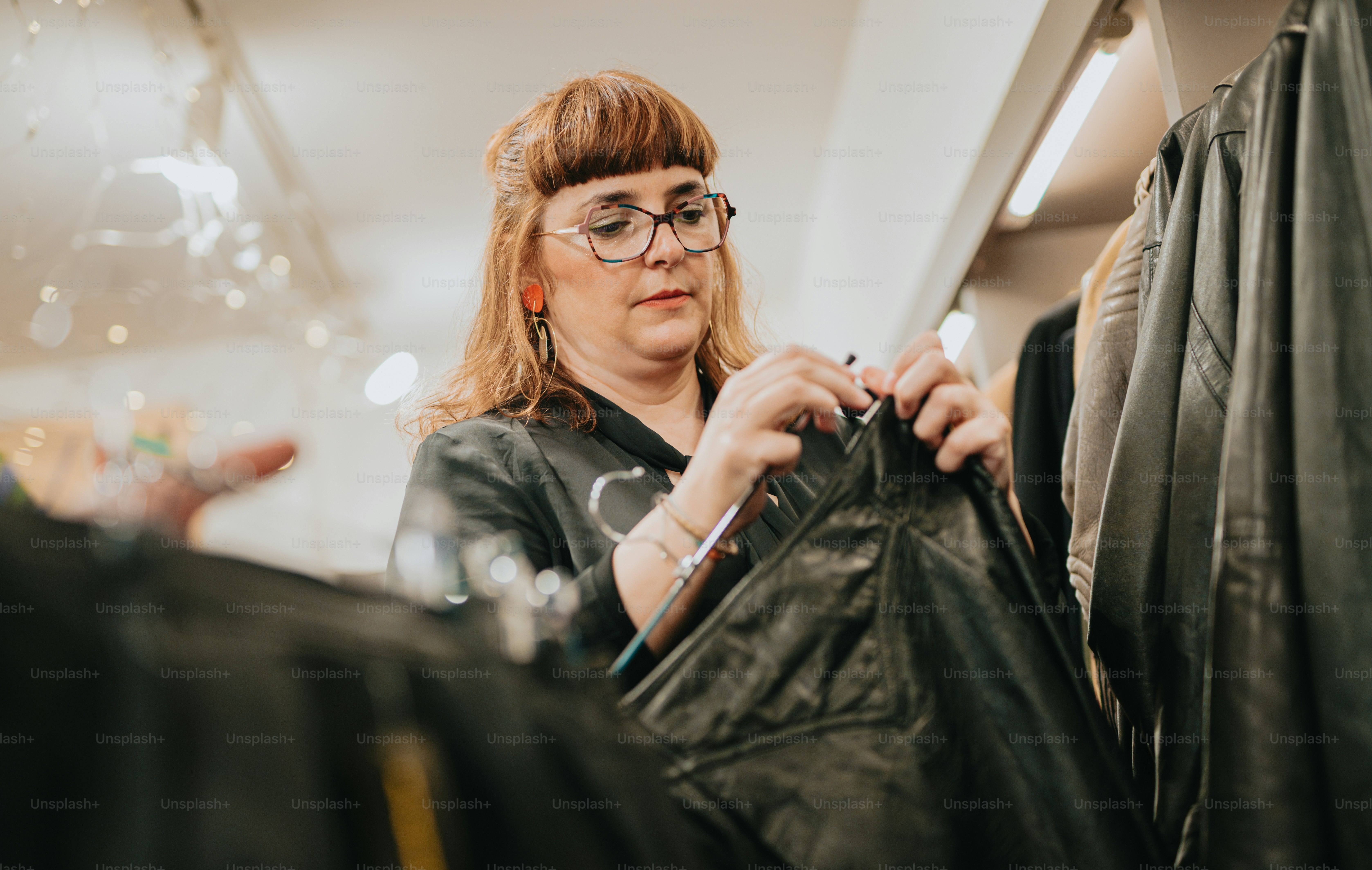 Une femme regarde une veste en cuir