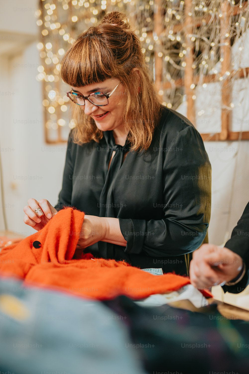 a woman is working on a piece of cloth