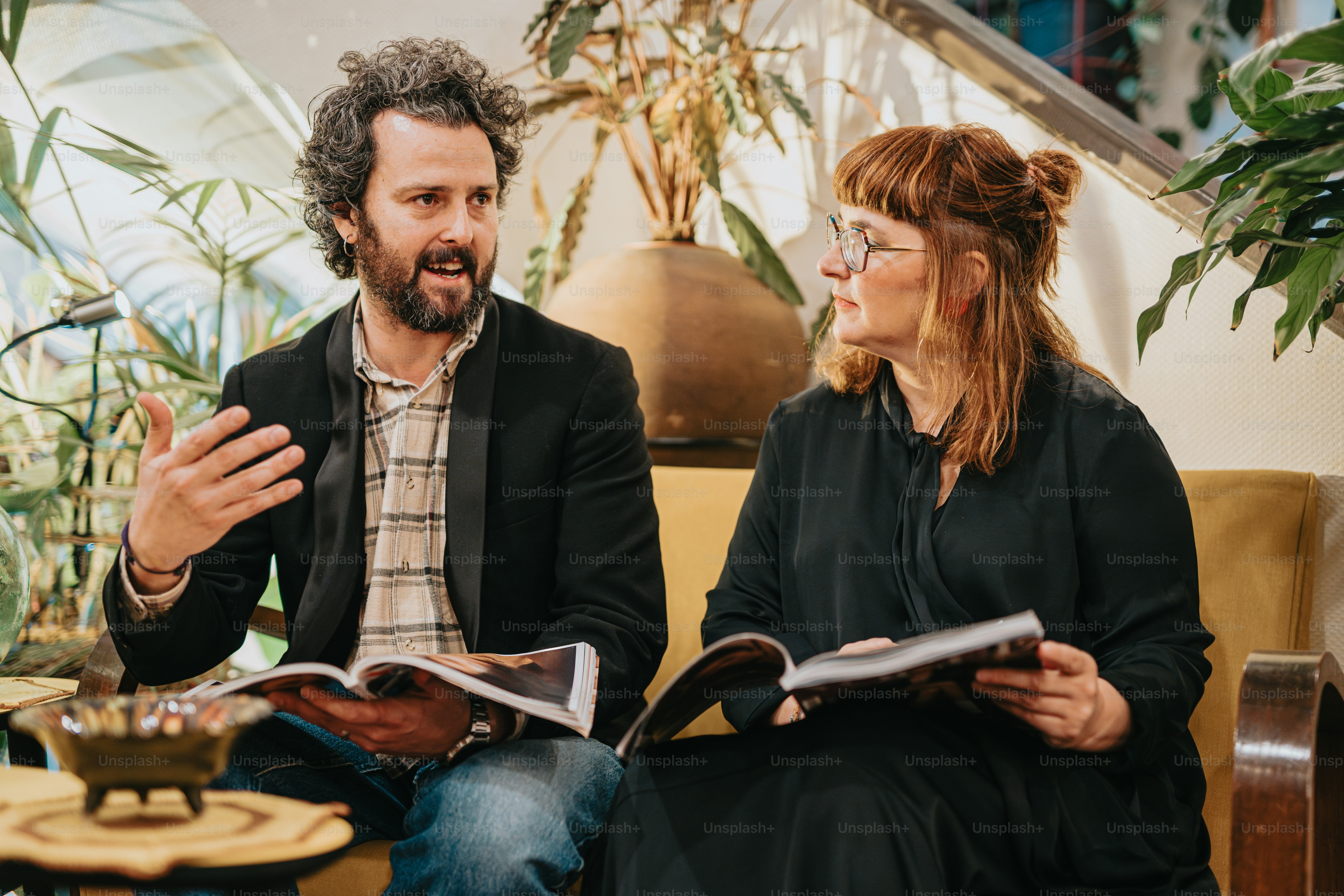 a man and a woman sitting on a couch talking