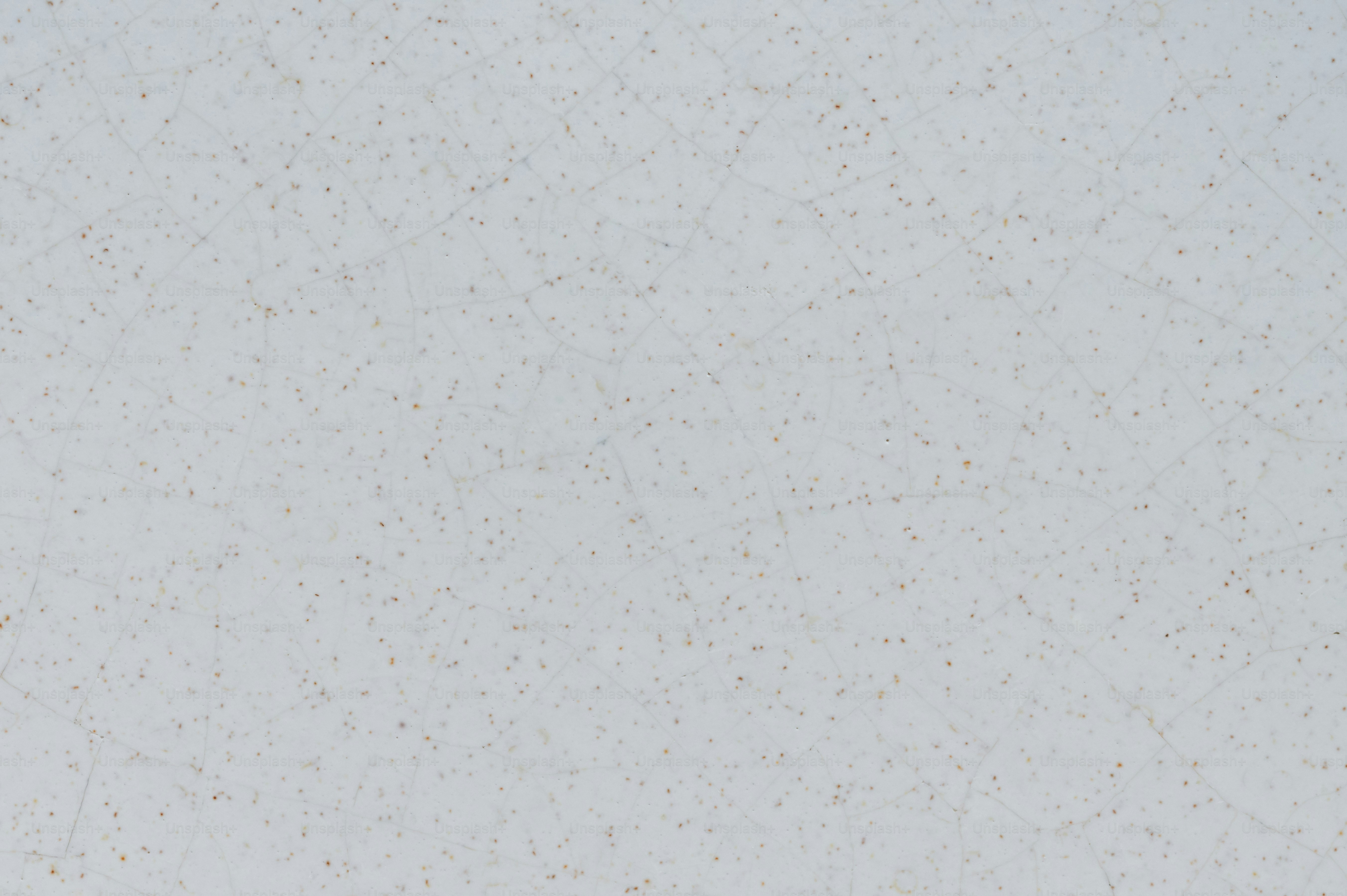 A white and gold speckled wallpaper with a white background photo
