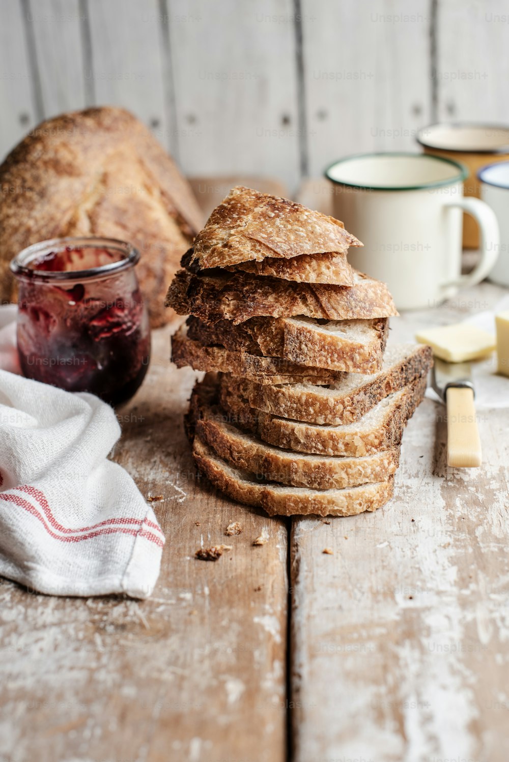 a stack of bread sitting on top of a wooden table