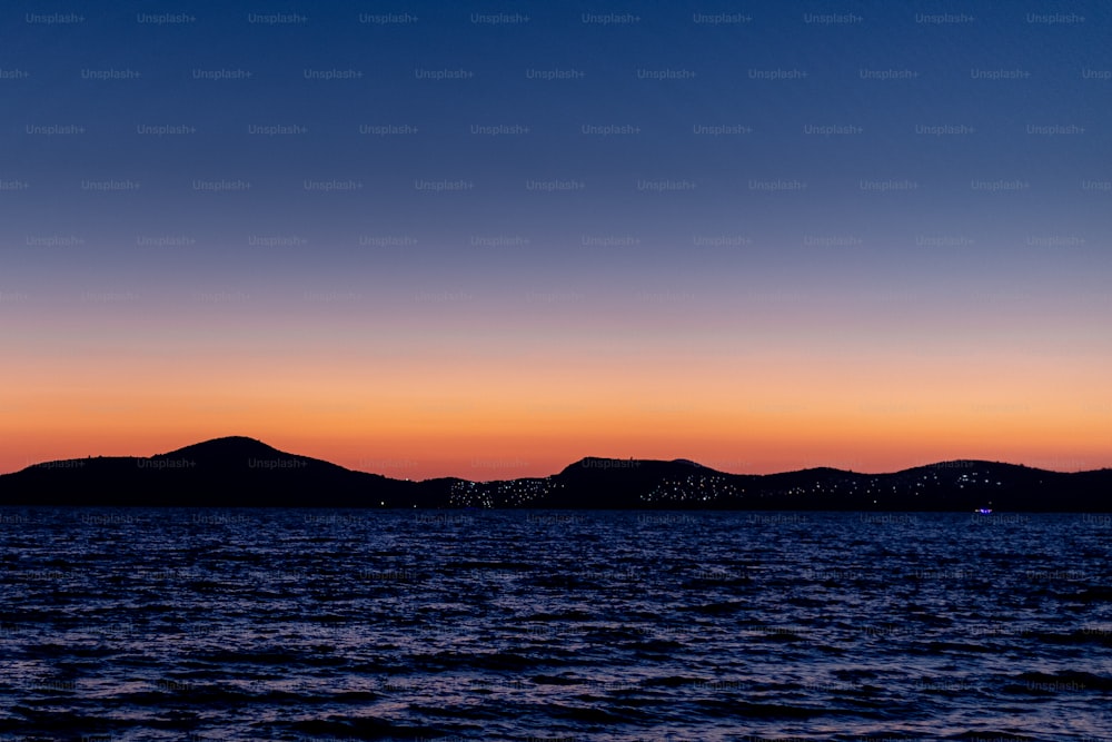 a view of a body of water with mountains in the background