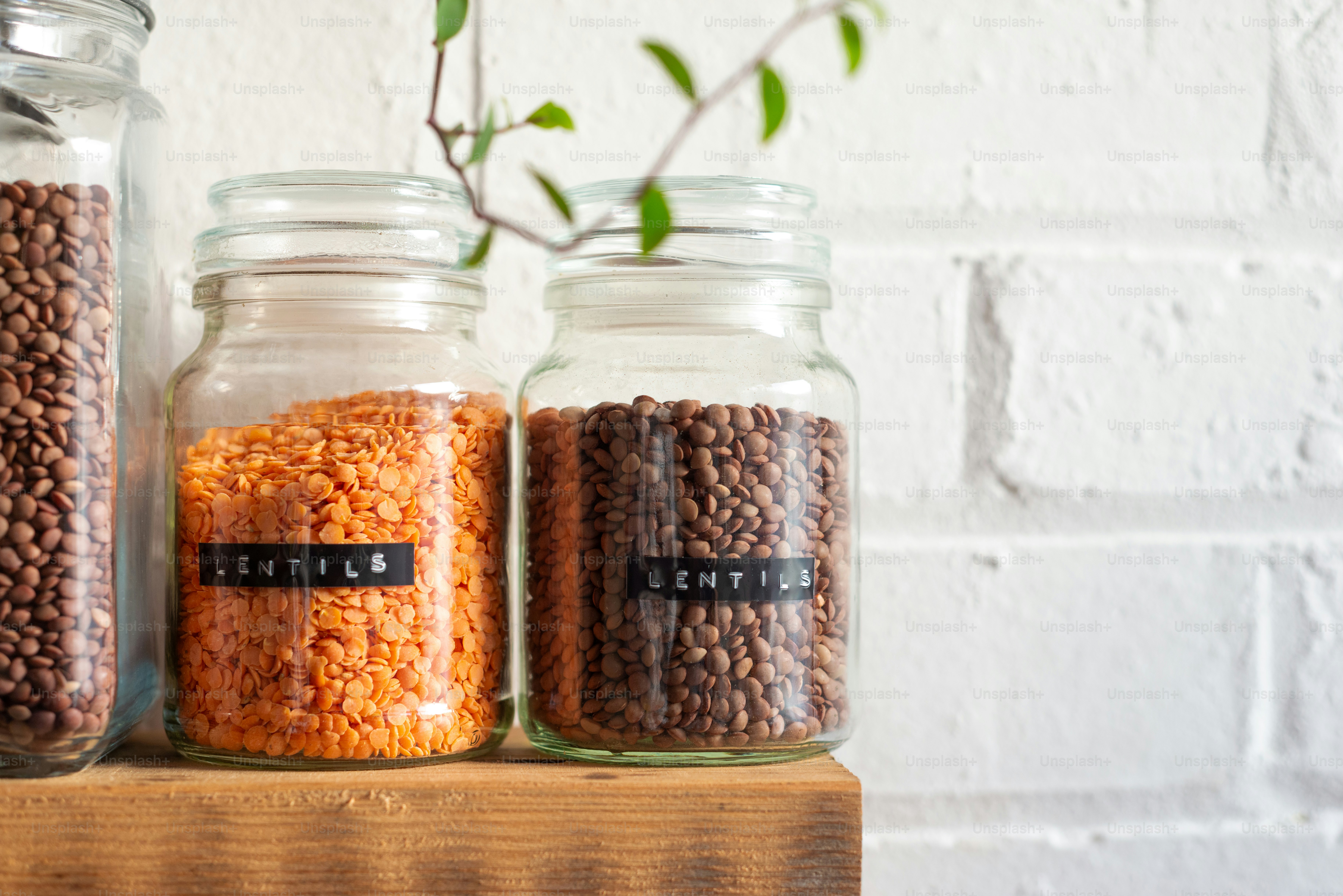 three jars filled with different types of beans