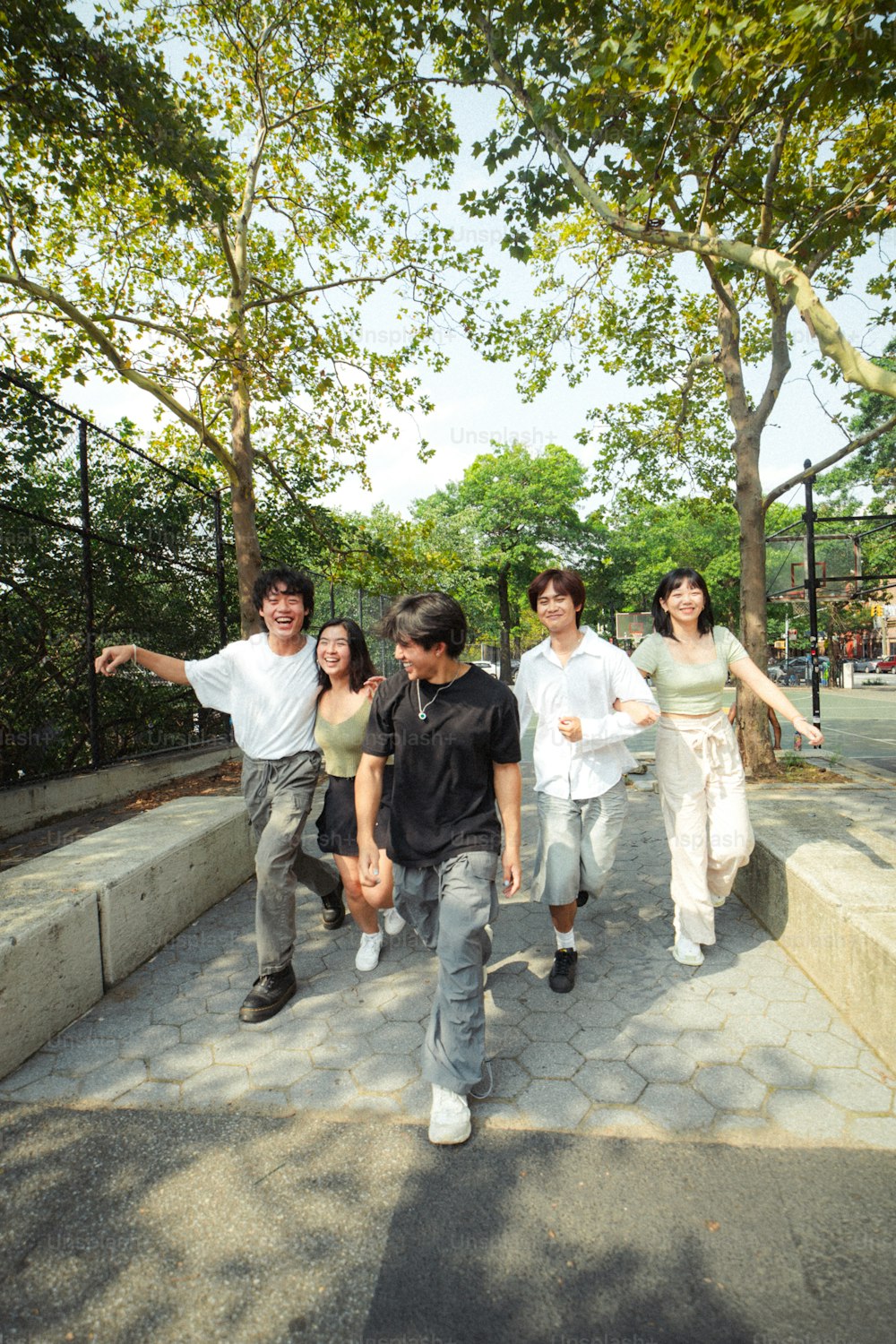 a group of people walking down a sidewalk