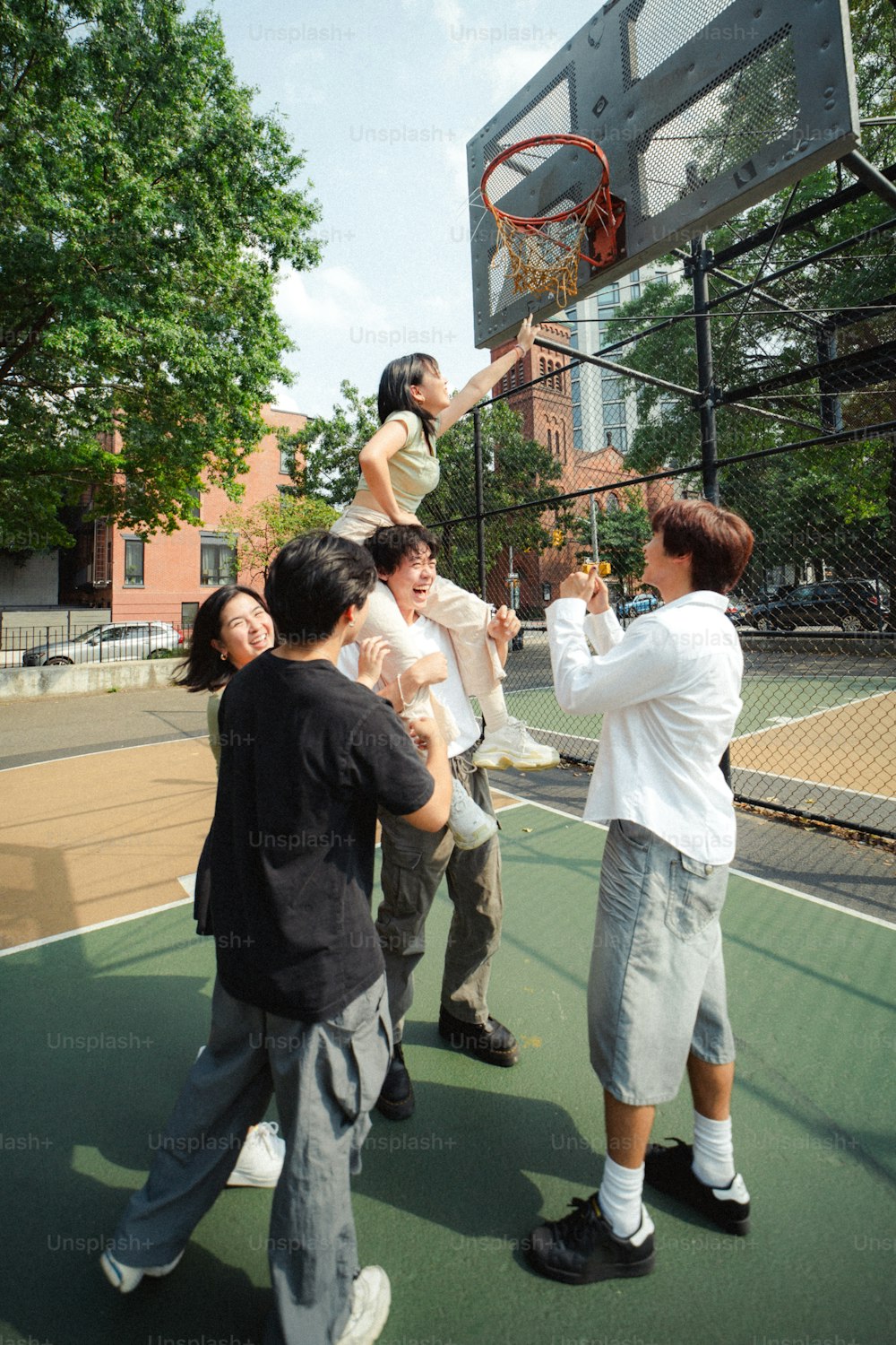 a group of people standing on top of a basketball court