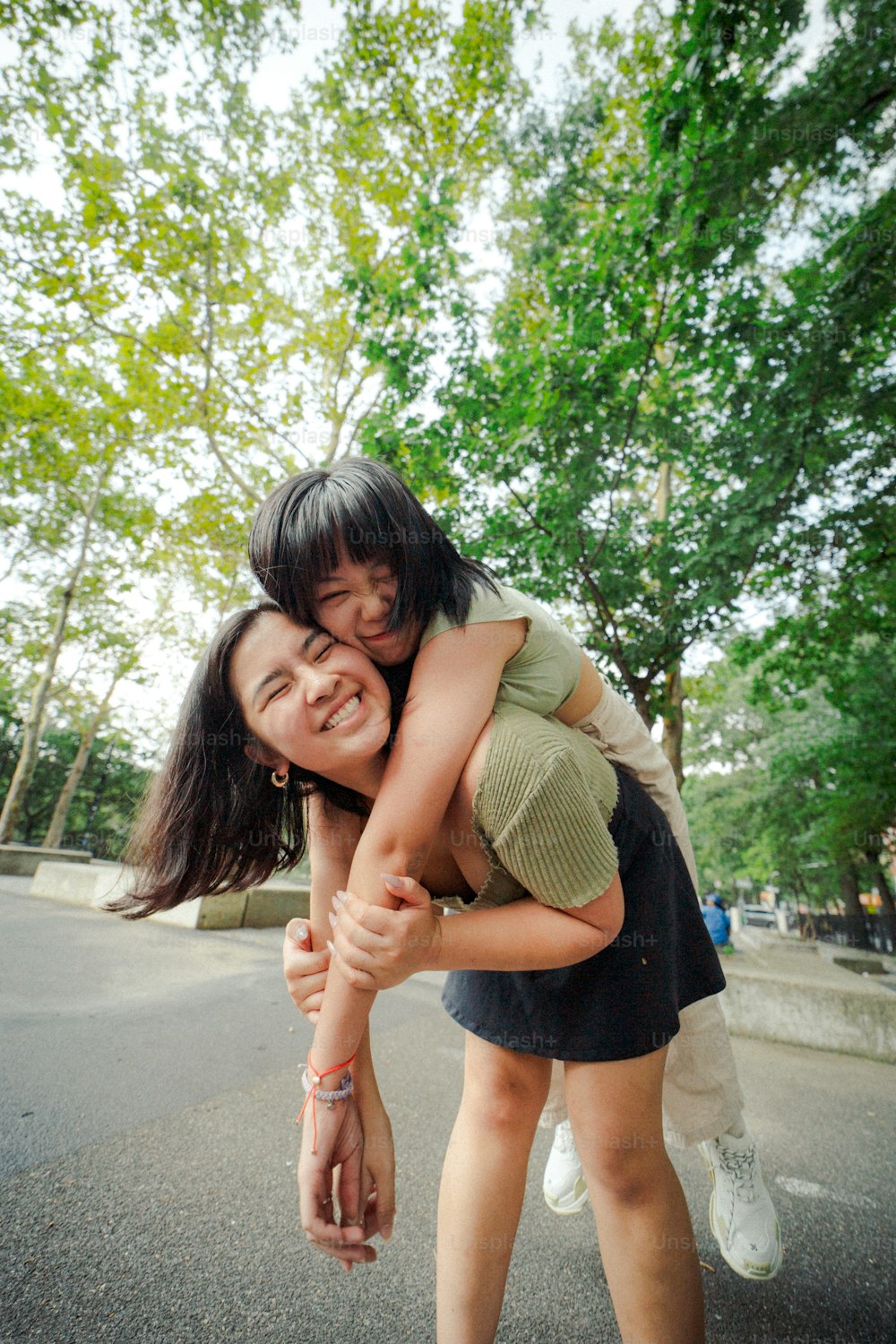 a woman is hugging a young girl on a skateboard