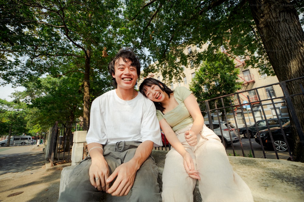 a man and a woman are sitting on a bench