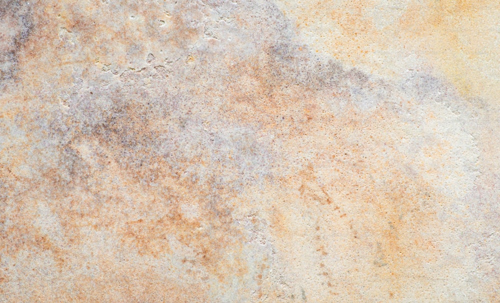 a close up of a wall with a rusted surface