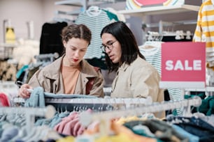 a couple of women standing next to each other in a store
