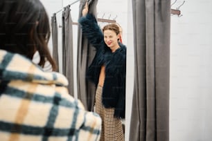 a woman standing in front of a mirror