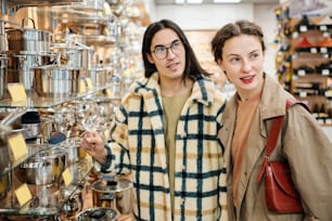 a man and a woman standing next to each other in a store