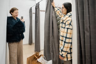 a woman looking at a coat hanging on a rack