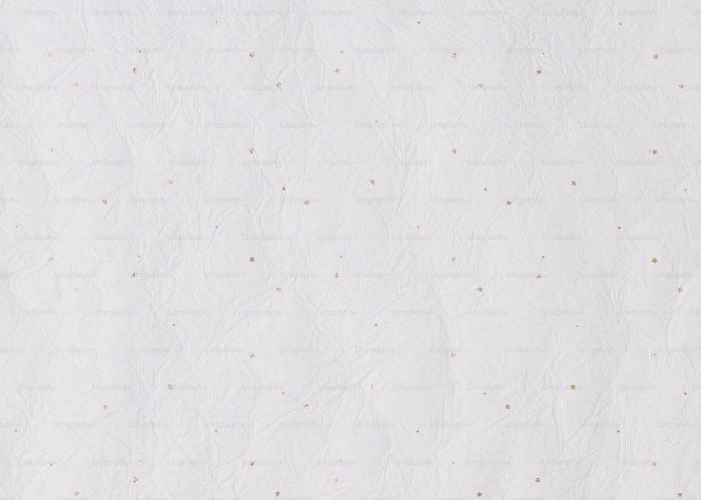 a white sheet of paper with gold dots on it