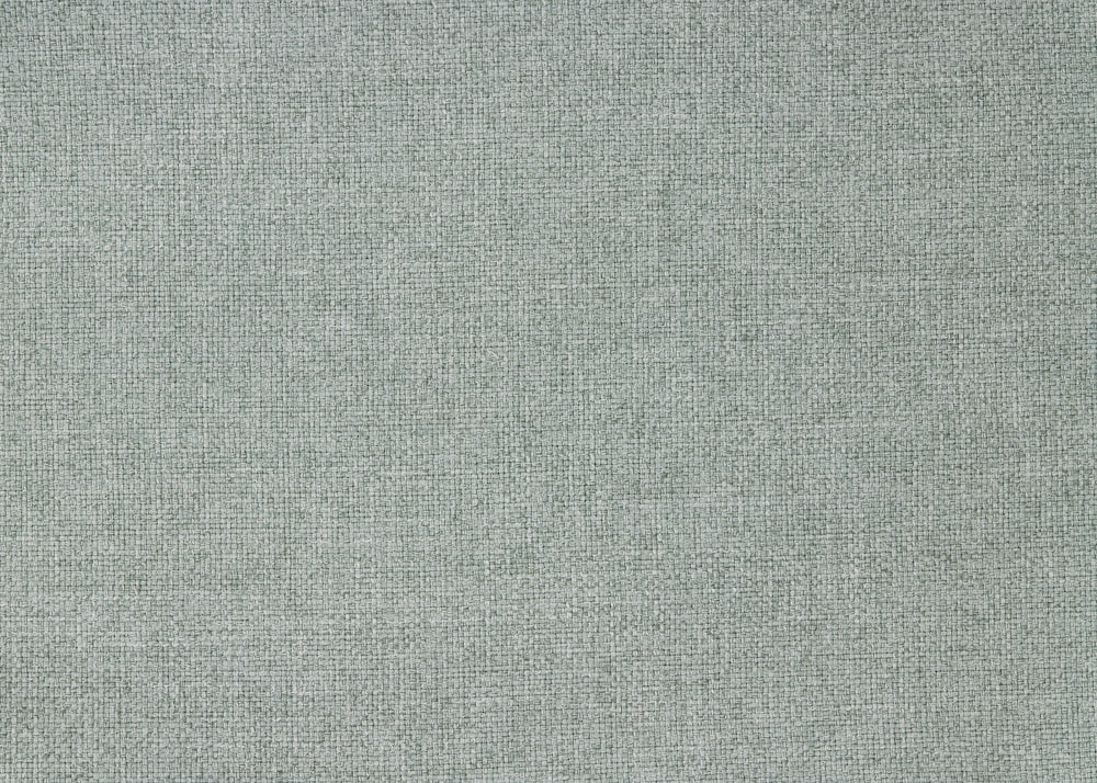 a light blue fabric textured with small squares