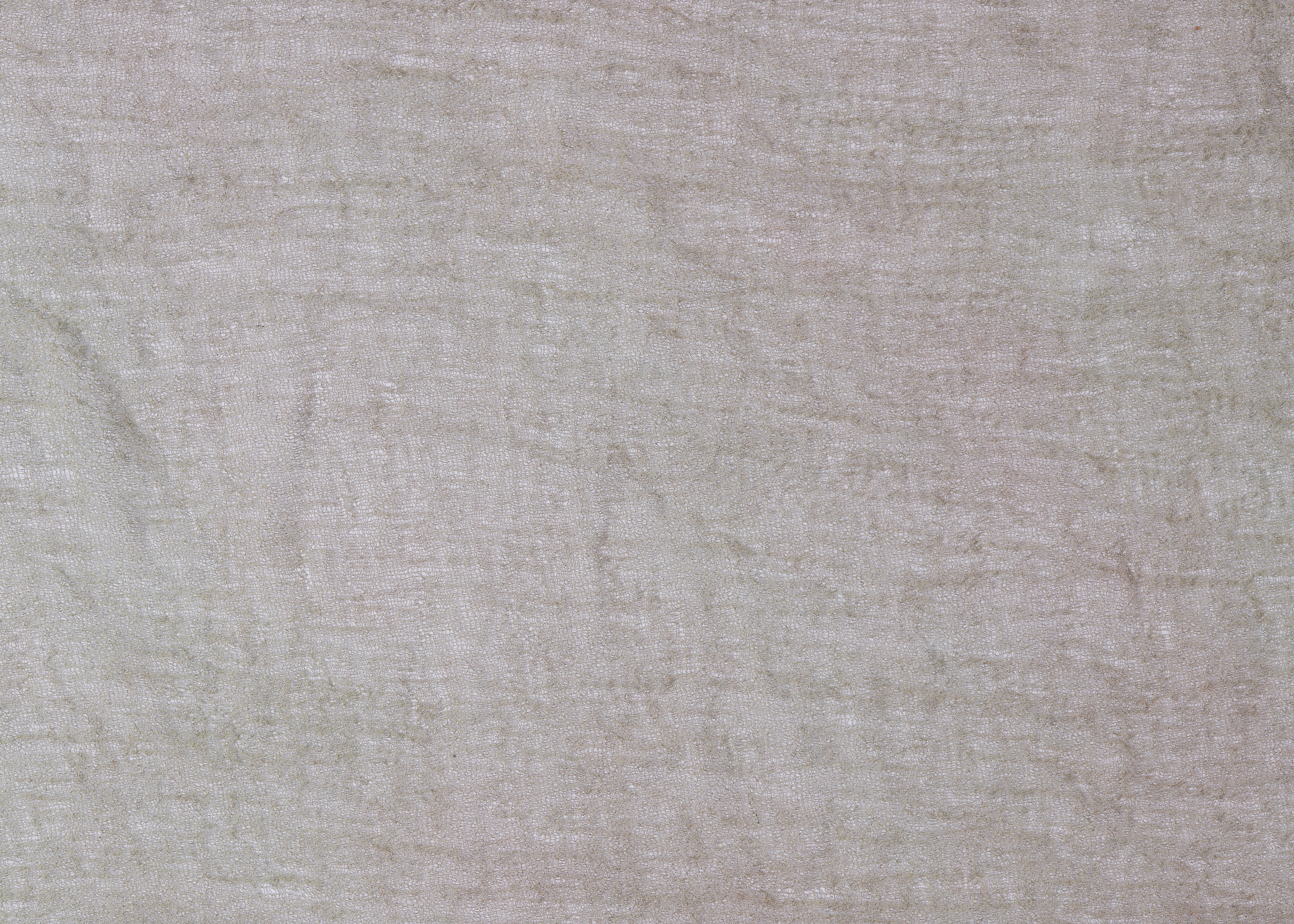 a cat is sitting on the floor next to a wall