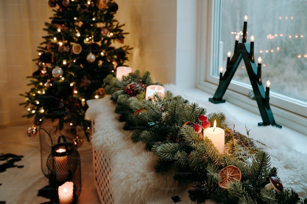 a christmas tree is next to a window sill