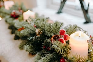 a candle is lit on a christmas garland