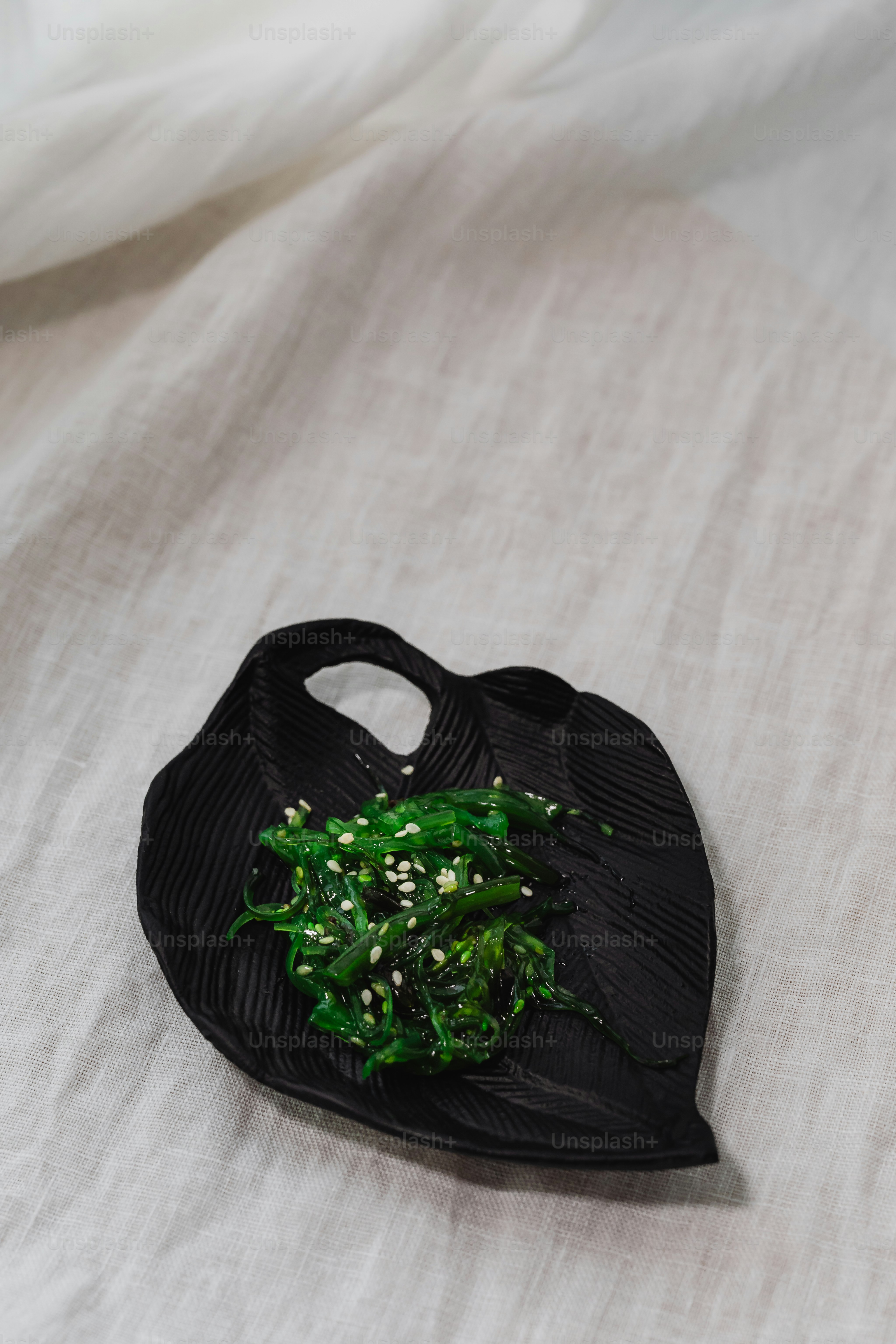 a black bag with a bunch of broccoli in it