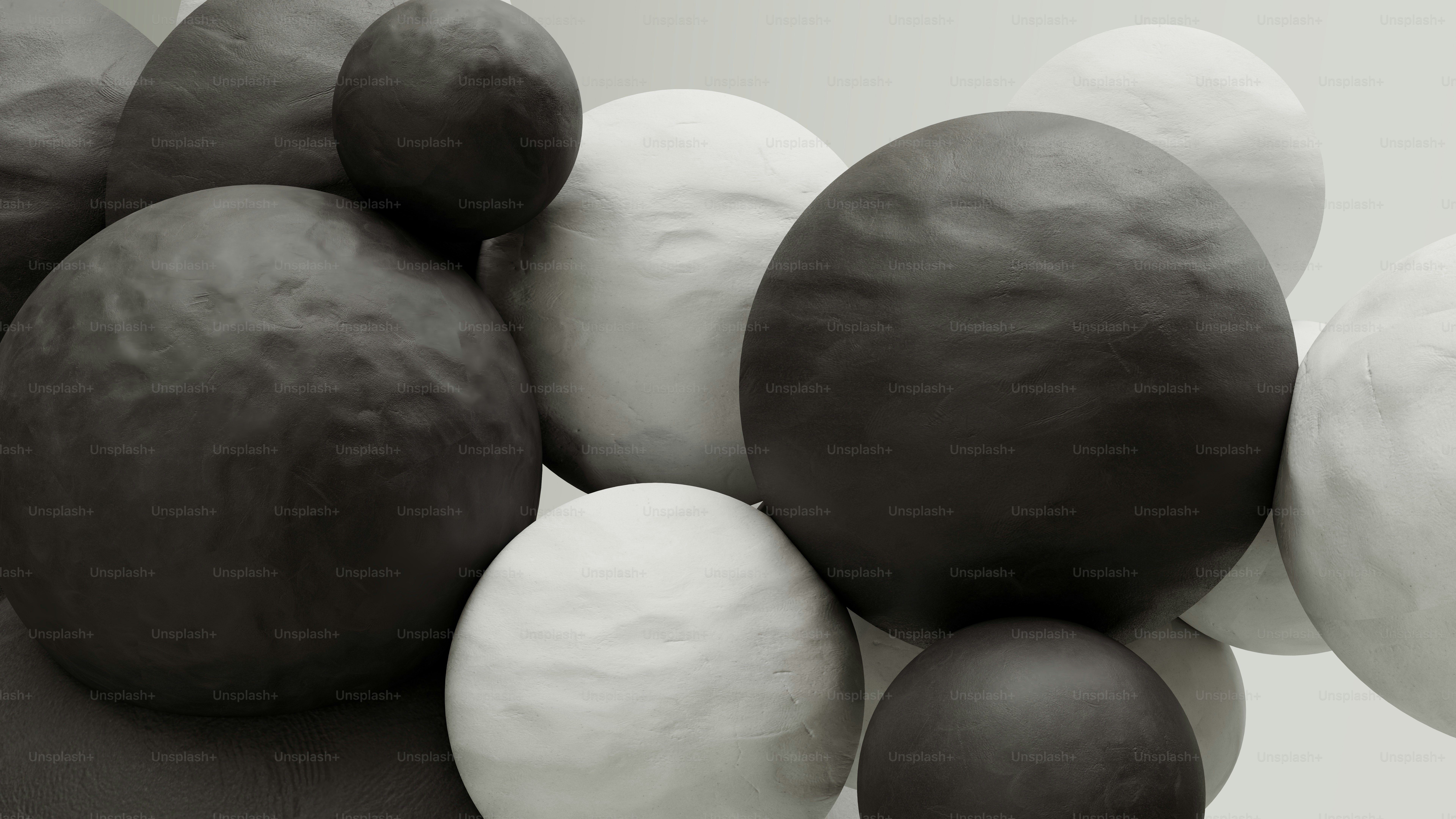 A group of black and white balls sitting on top of each other photo ...