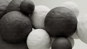 a group of black and white balls sitting on top of each other