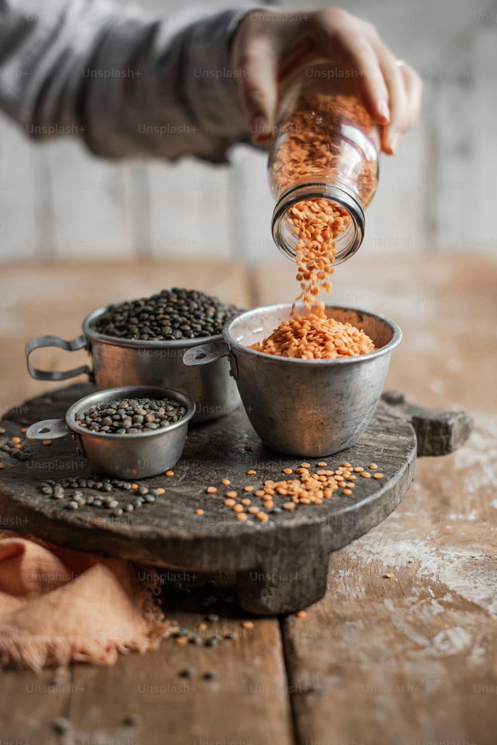 a person pouring some food into a bowl