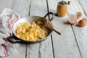 a pan of macaroni and cheese with a wooden spoon