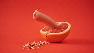 a grapefruit cut in half with a knife sticking out of it