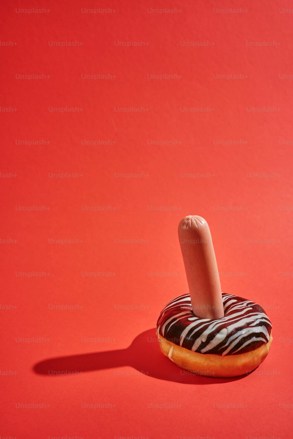 a donut with a candy stick sticking out of it